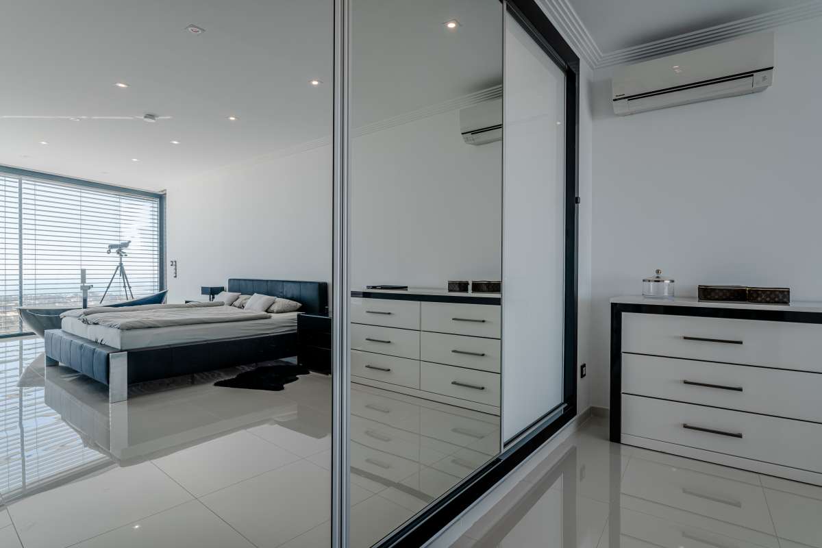Main suite wardrobe area with contemporary fitted storage inside a luxury villa in Gran Sol, Calpe.