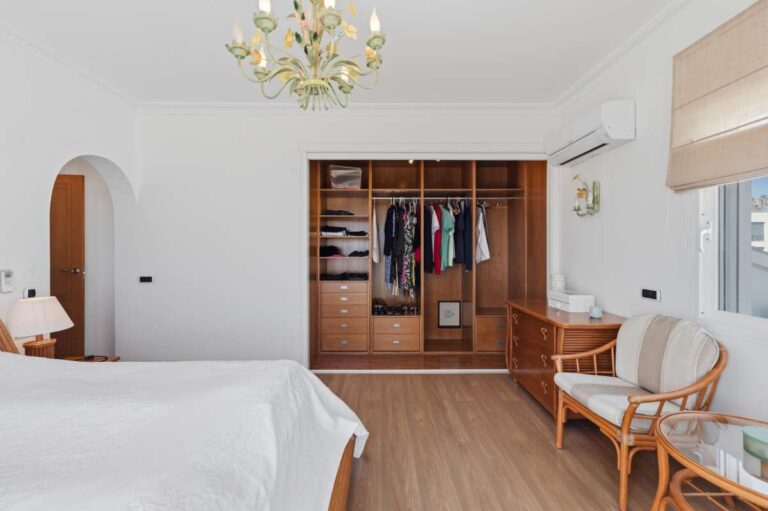 Master bedroom with fitted storage and natural light inside a villa in Calpe.