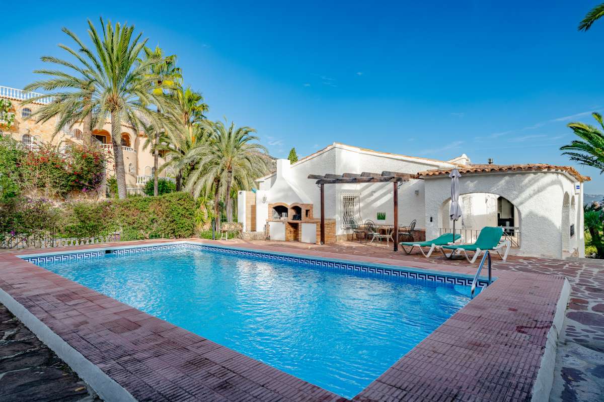 Mediterranean villa in Maryvilla, Calpe with private swimming pool, terrace and palm trees near the beach and marina.