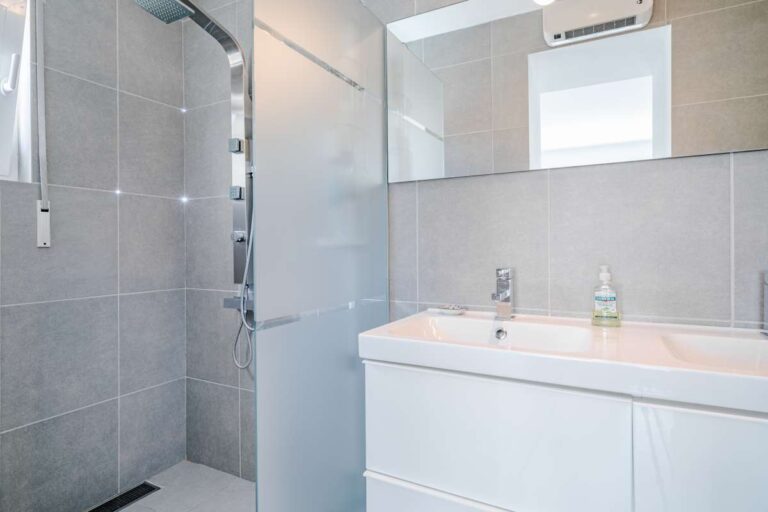 Modern bathroom inside a Calpe villa with walk-in shower, vanity unit and natural light