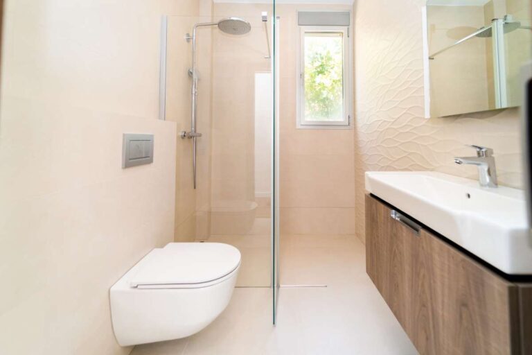 Modern bathroom inside a luxury villa in Calpe with walk-in shower, vanity unit, toilet and bright tiled finish