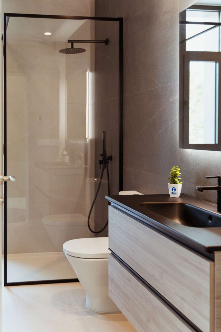 Modern bathroom inside a new-build luxury villa in Moraira with walk-in shower, vanity unit, toilet and natural light