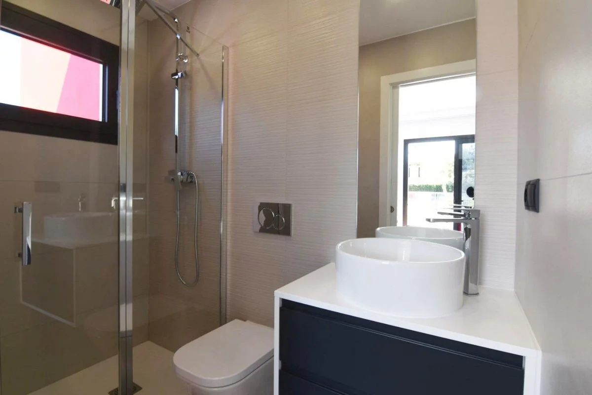Modern bathroom with glass shower and vanity in villa in Calpe