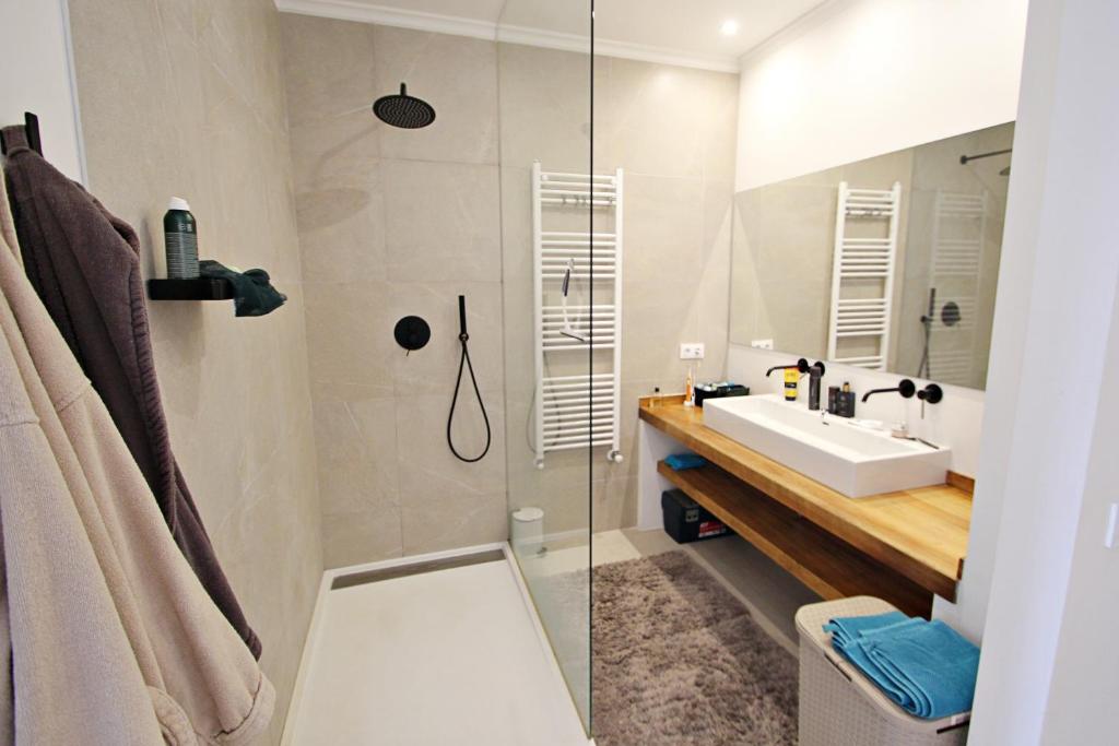 Modern bathroom with walk-in shower and double sink at villa in Moraira
