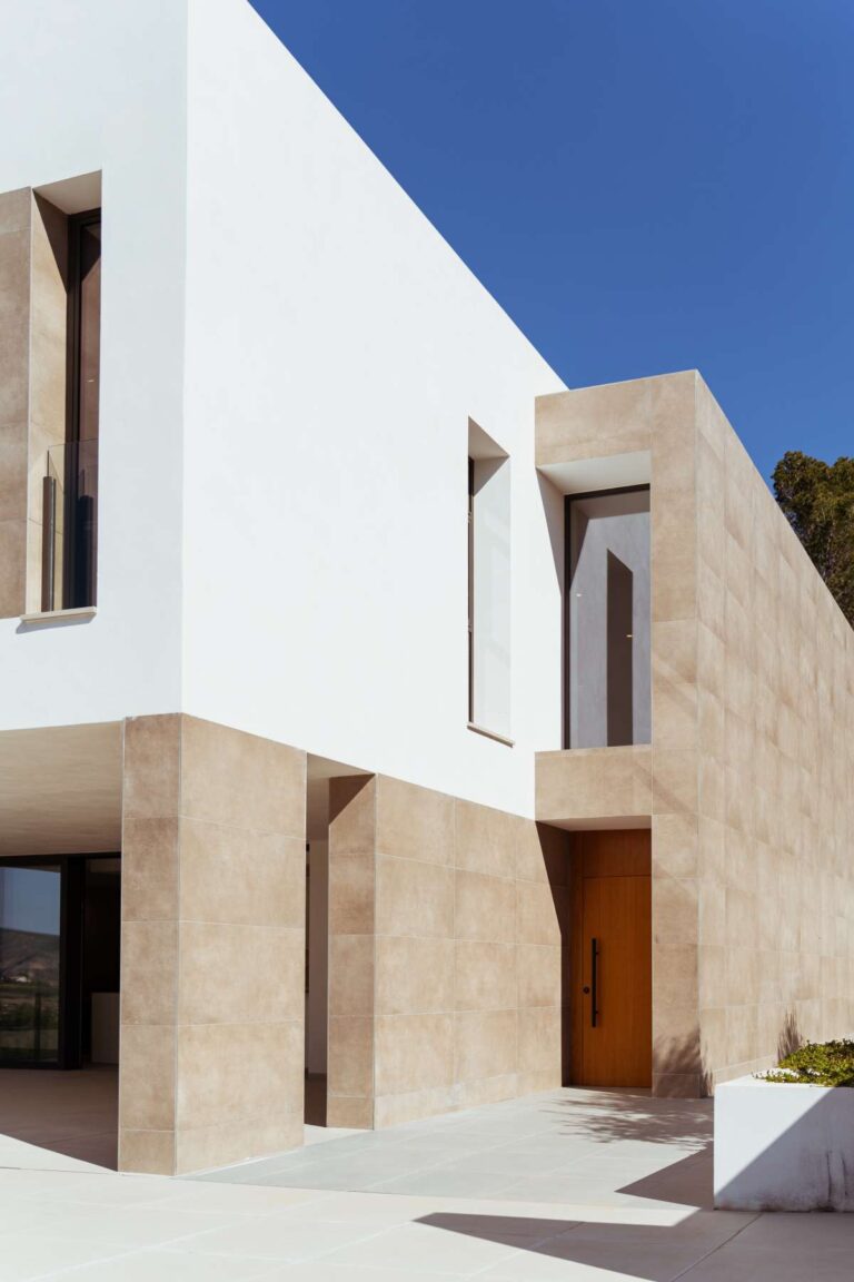 Modern entrance exterior of a new-build luxury villa in Moraira with white façade, stone detailing and contemporary architectural design