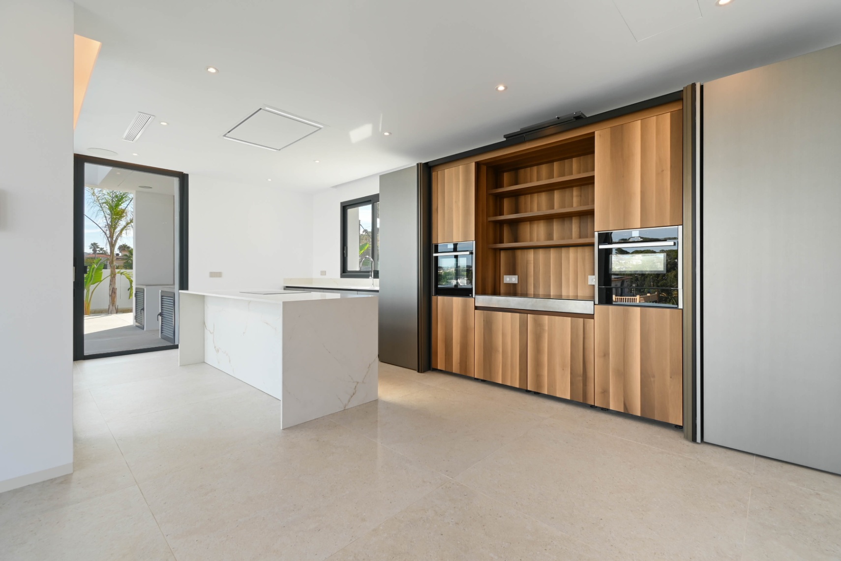 Modern kitchen with wood cabinetry at newly built luxury villa in Benissa