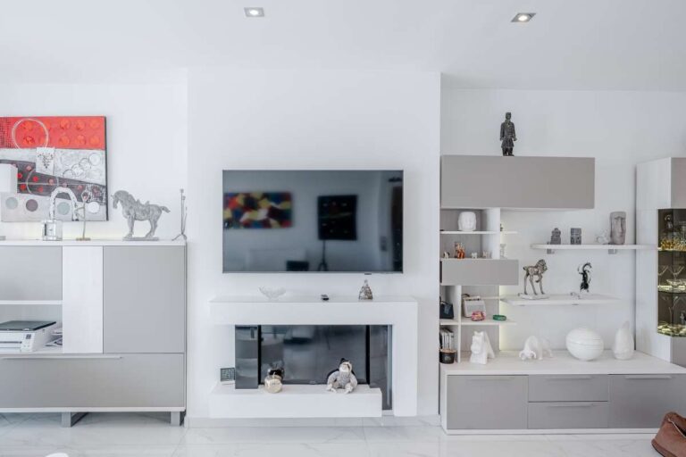 Modern living area inside a renovated apartment in Arenal-Bol, Calpe with fireplace, TV wall and built-in shelving