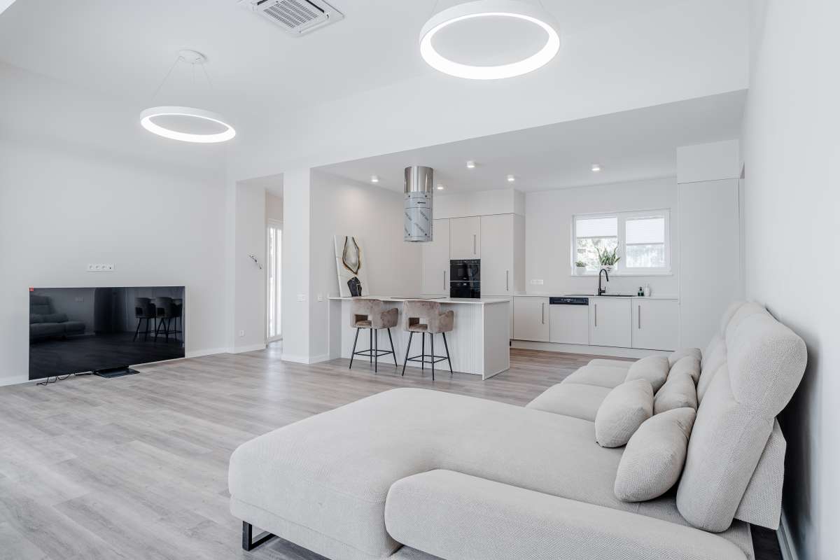 Modern living area with open plan kitchen inside a new build villa for sale in Calpe