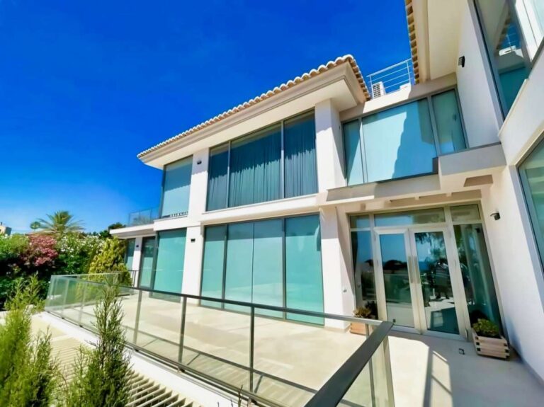 Modern luxury villa exterior in La Calalga, Calpe with large glass windows, terrace railings and contemporary architectural design