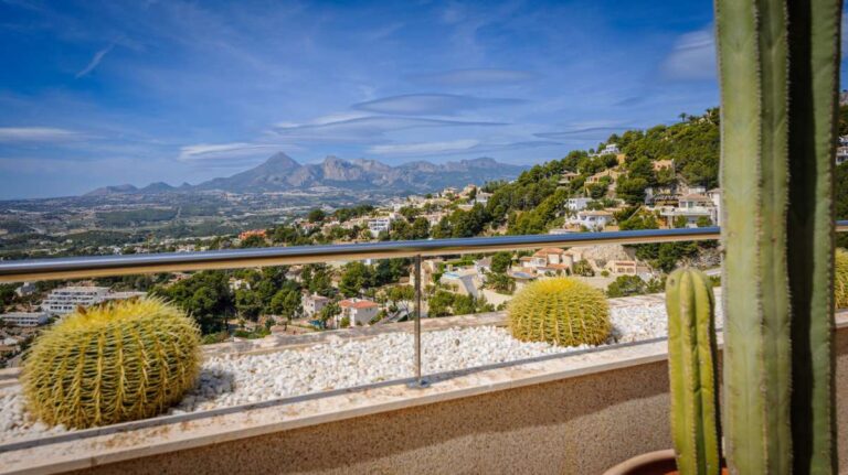 Mountain and sea views from a luxury apartment terrace in Sierra de Altea with terrace railing, Mediterranean planting and coastline views