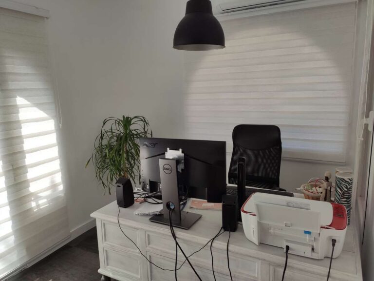 Office area with desk, computer setup and natural light inside a refurbished villa with three independent apartments in Canuta, Calpe.