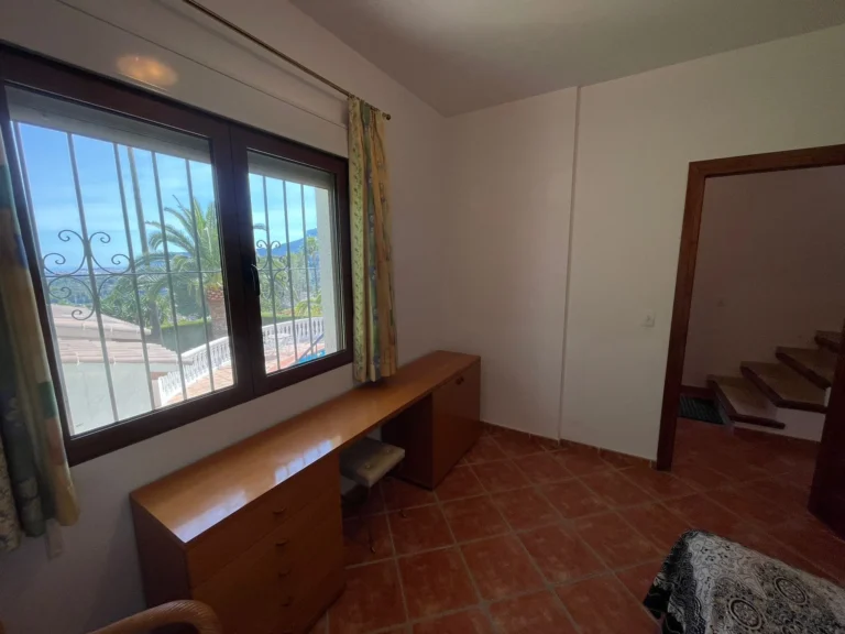 Office room with built-in desk, large window, and views inside a villa in Calpe.