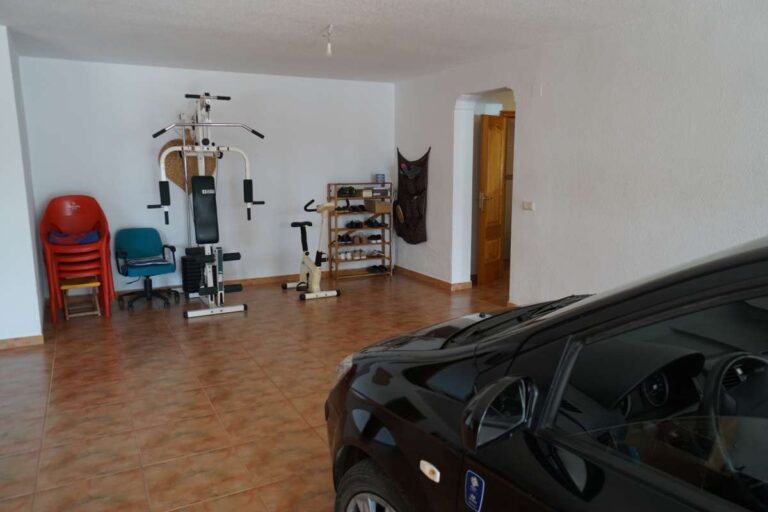 Open interior living space with traditional furniture inside a Mediterranean villa near La Calalga Beach in Calpe.