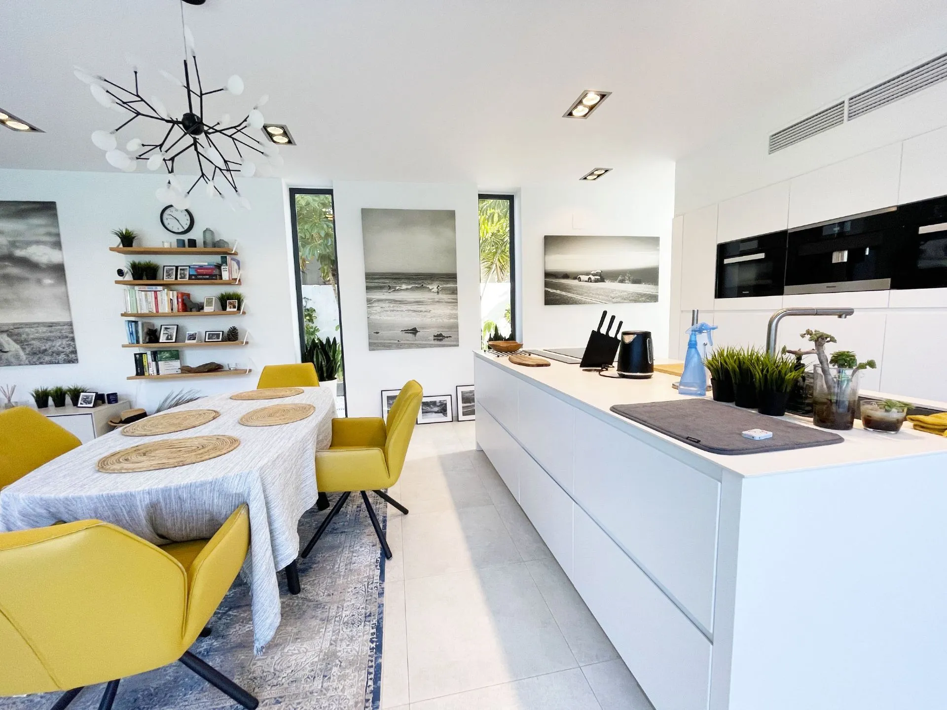 Open kitchen beside dining area at modern villa in Calpe