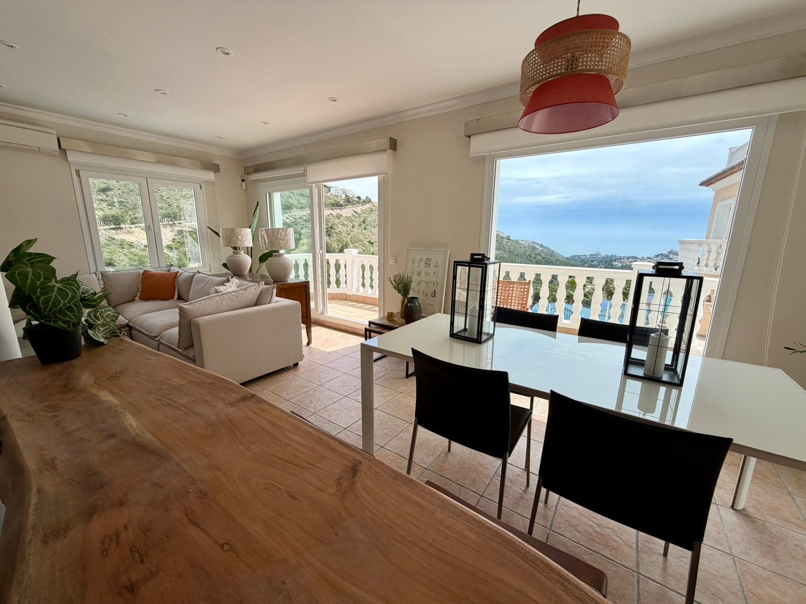 Open-plan dining and lounge area with sea views at villa in Moraira