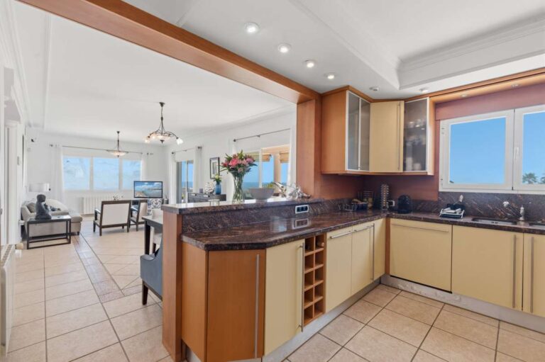 Open-plan kitchen and living area inside a villa in Calpe with sea views.