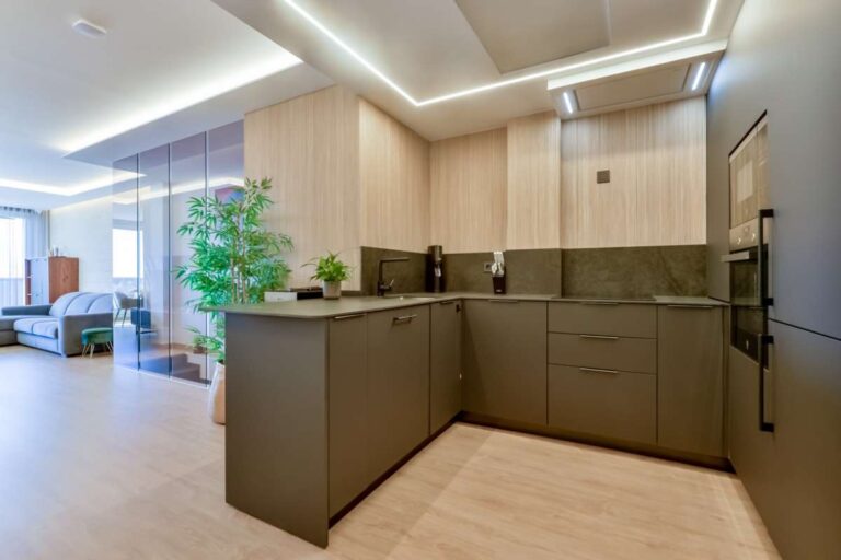 Open-plan kitchen inside a luxury frontline beach duplex in Mascarat, Altea with modern cabinetry, integrated appliances and connection to the living area