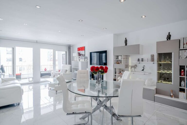 Open-plan living and dining area inside a renovated apartment in Arenal-Bol, Calpe with sea-facing windows and bright modern interior
