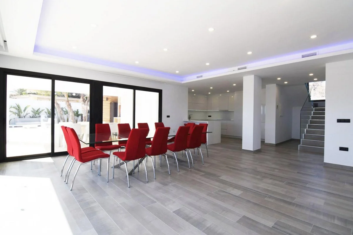 Open-plan living and dining area with terrace access in modern Calpe villa