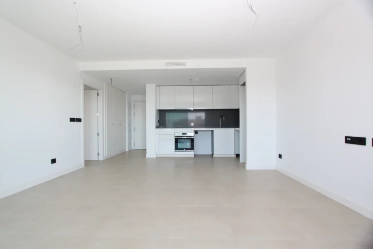 Open-plan living area and kitchen inside modern penthouse in Calpe