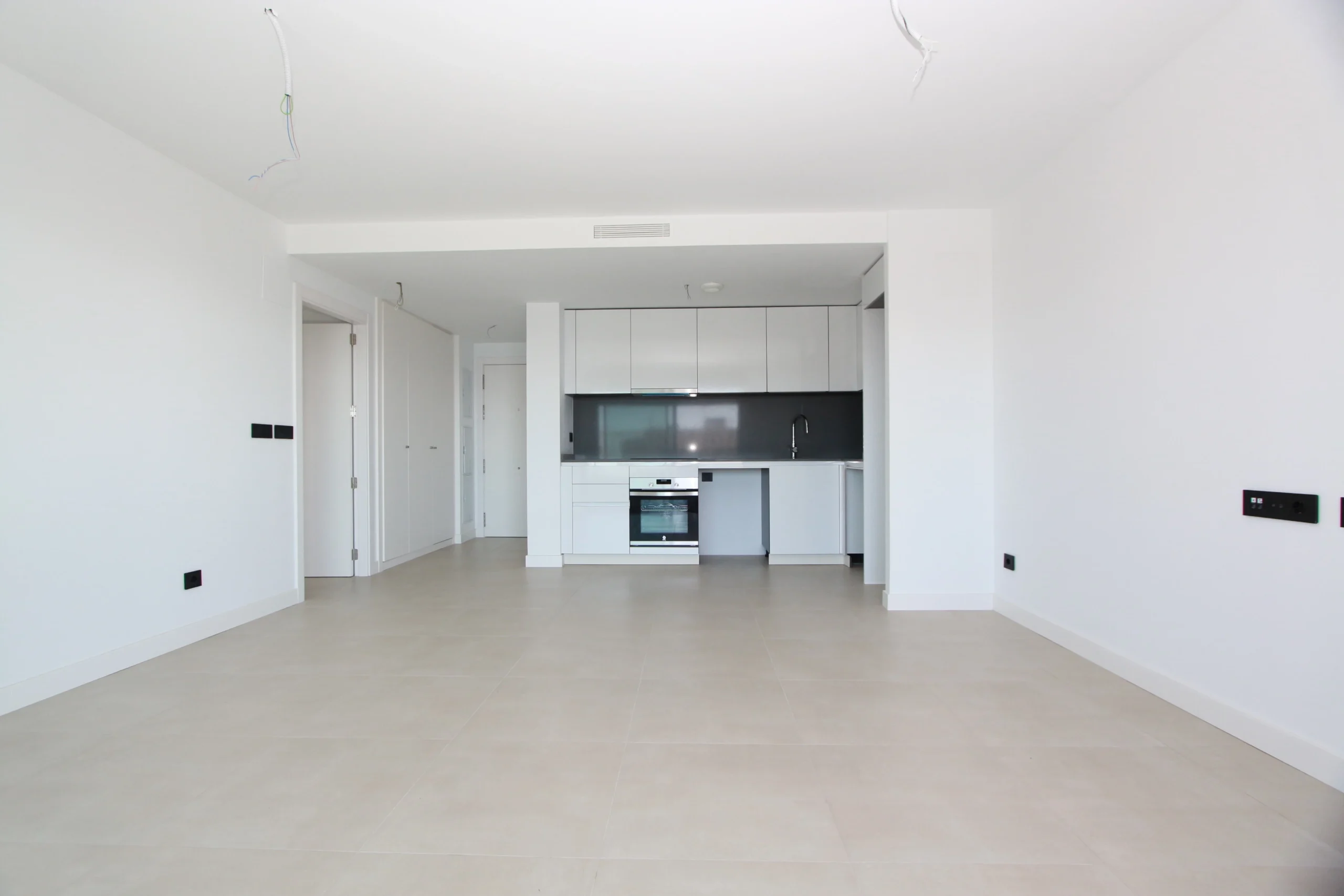 Open-plan living area and kitchen inside modern penthouse in Calpe