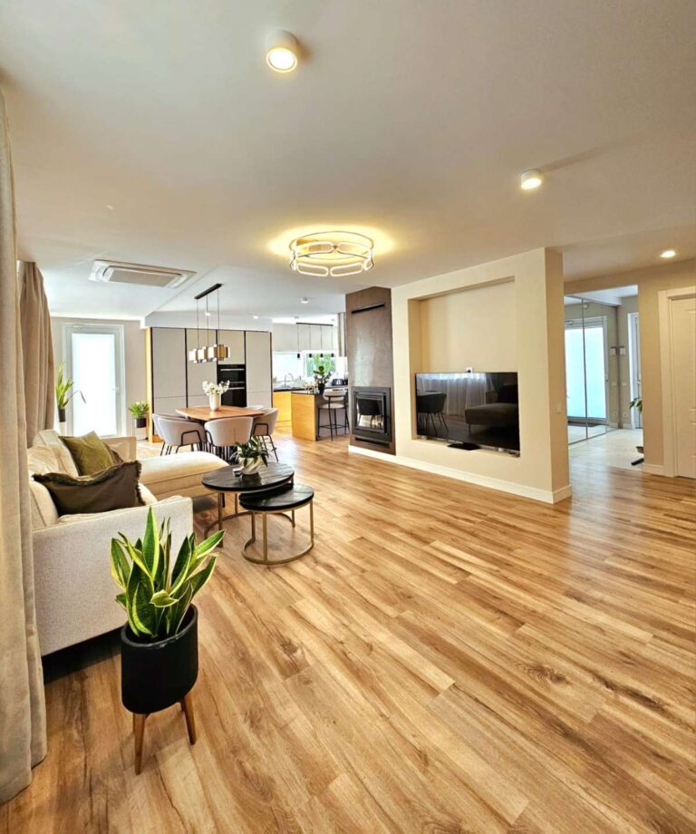 Open-plan living area inside a modern villa near Les Bassetes, Calpe with fireplace, dining space and natural light