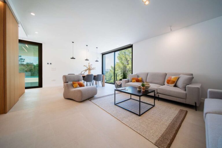 Open-plan living area inside a new-build luxury villa in Moraira with large windows, modern seating area and bright interior finish