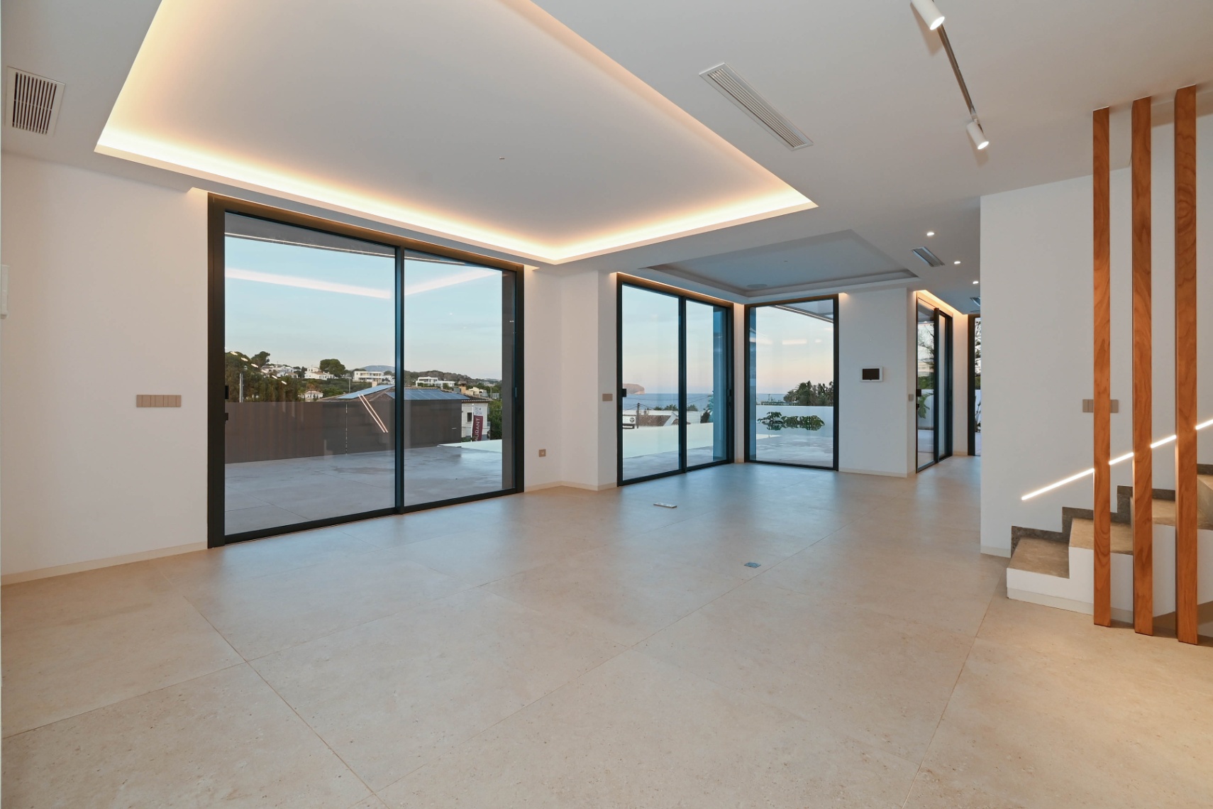 Open-plan living area with large glass doors at luxury villa in Benissa