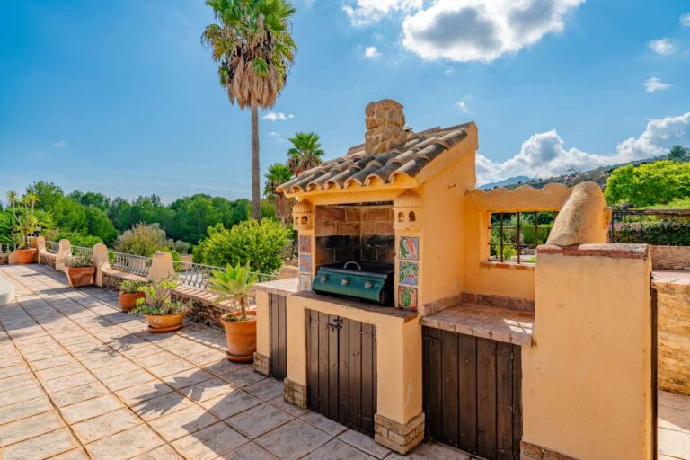 Outdoor barbecue area at a historic finca in Benissa with terrace space, Mediterranean planting and countryside surroundings