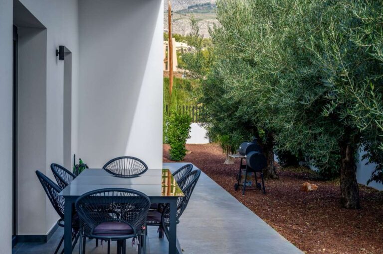Outdoor dining area at a single-level modern villa in Santa Clara, Altea with garden views, mature olive trees, patio seating and private outdoor space