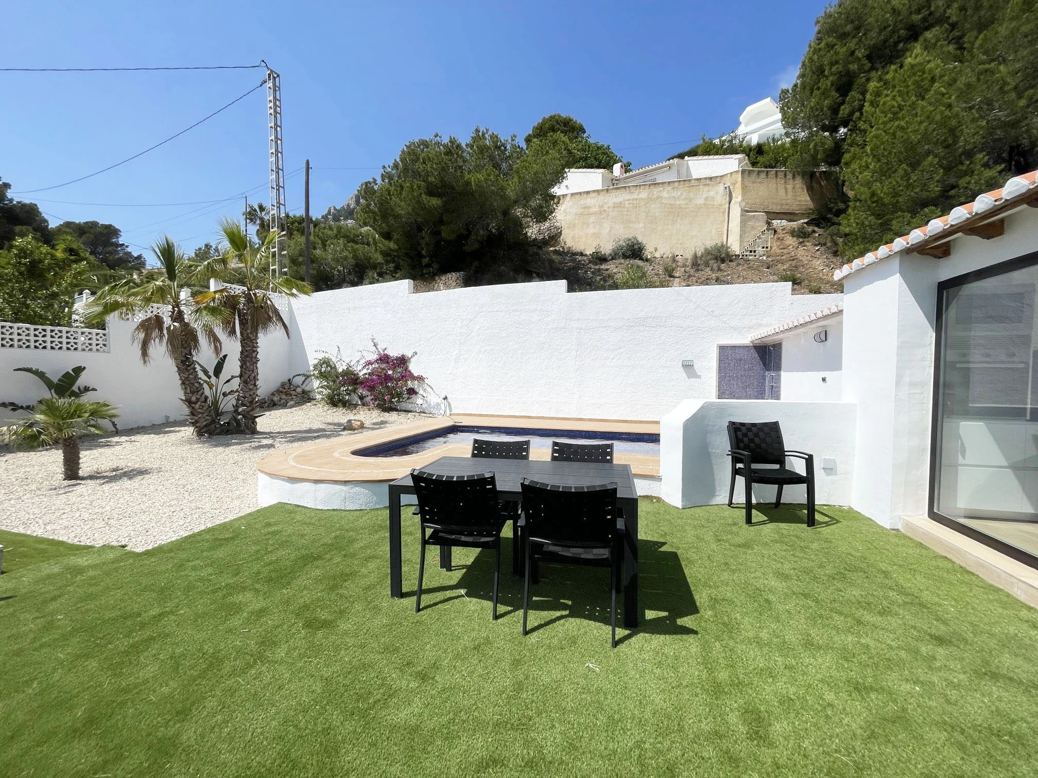 Outdoor dining area beside private pool at villa in Oltamar, Calpe