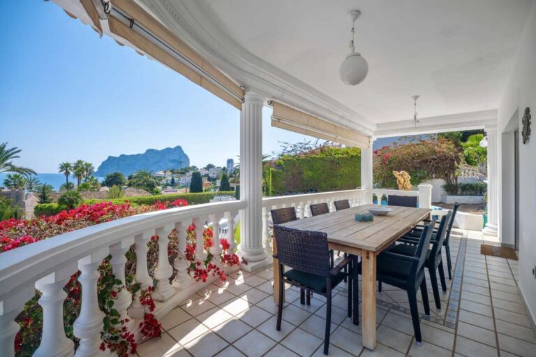 Outdoor dining area on a covered terrace with views towards the Peñón de Ifach in Calpe.