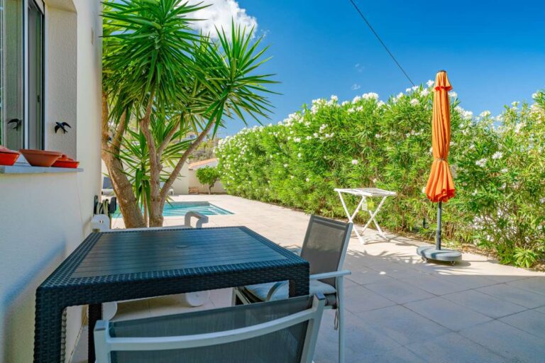 Outdoor dining terrace at a modern villa in Calpe with seating area, private outdoor space and Mediterranean garden views