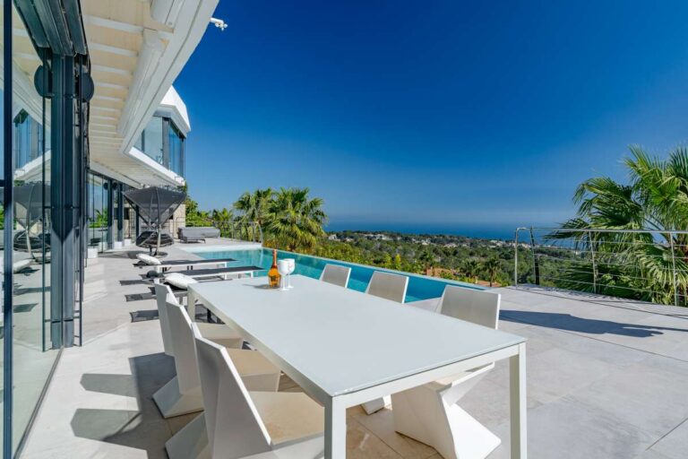 Outdoor dining terrace beside the infinity pool with panoramic sea views at a luxury villa in Gran Sol, Calpe.