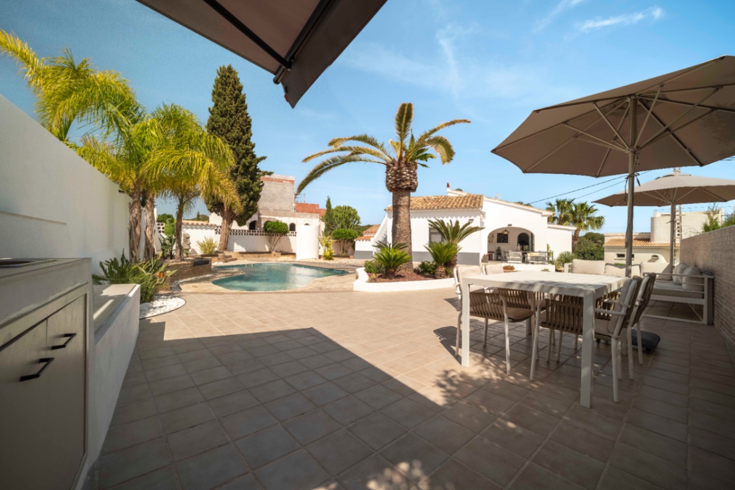 Outdoor kitchen and pool terrace at renovated Ibiza-style villa in Calpe