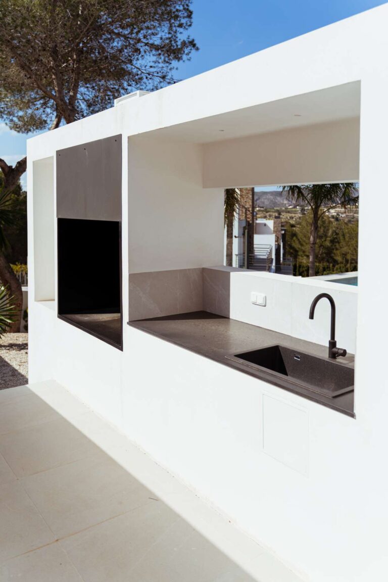 Outdoor kitchen at a new-build luxury villa in Moraira with sink, worktop, covered terrace and poolside entertaining space