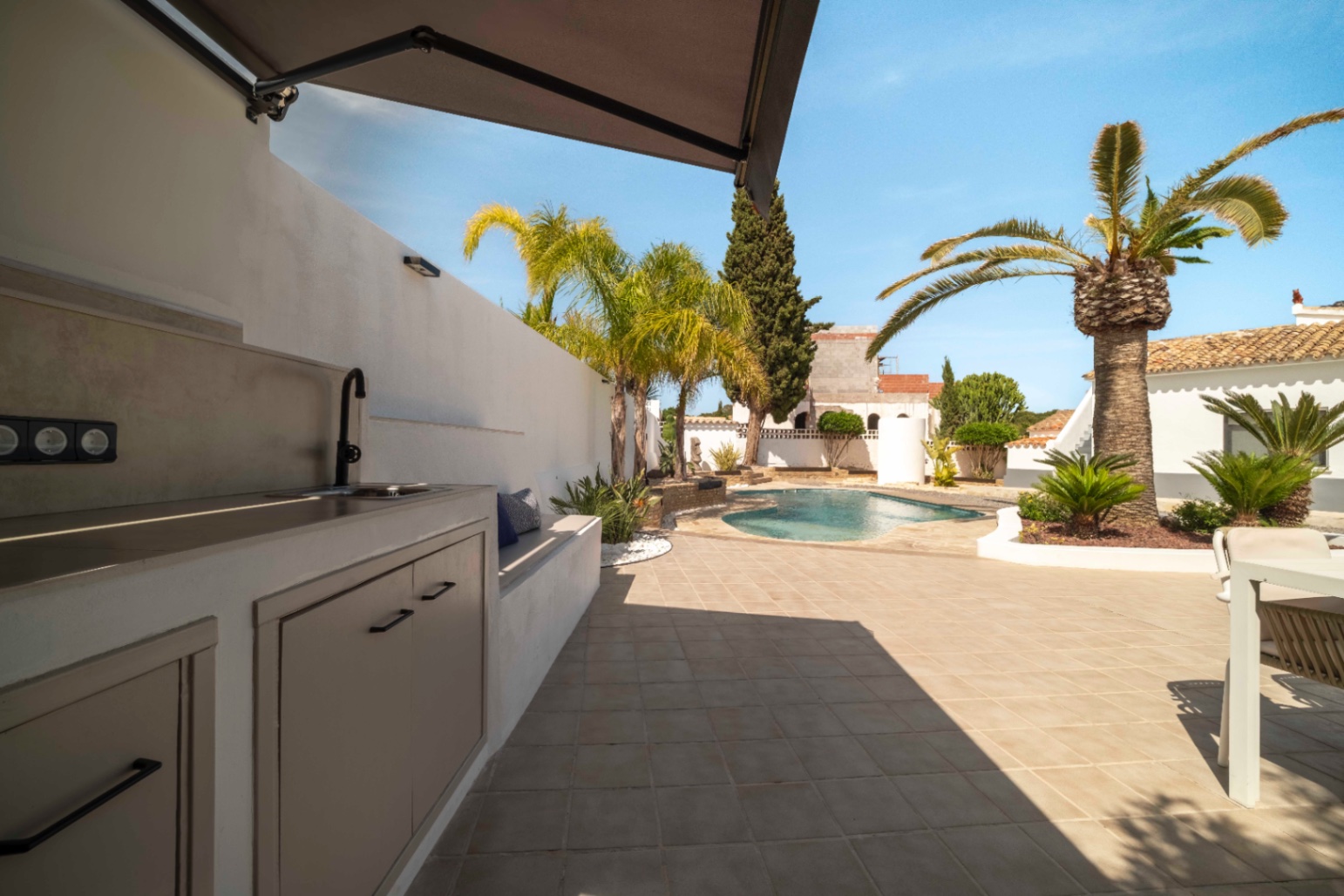 Outdoor kitchen with view towards private pool at villa in Calpe