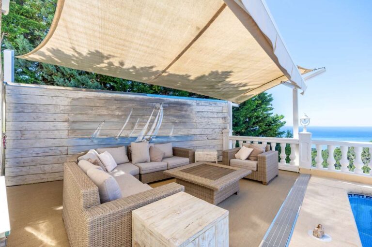 Outdoor lounge area at an elegant Mediterranean villa in Altea Hills with shaded seating, sea views and pool terrace access