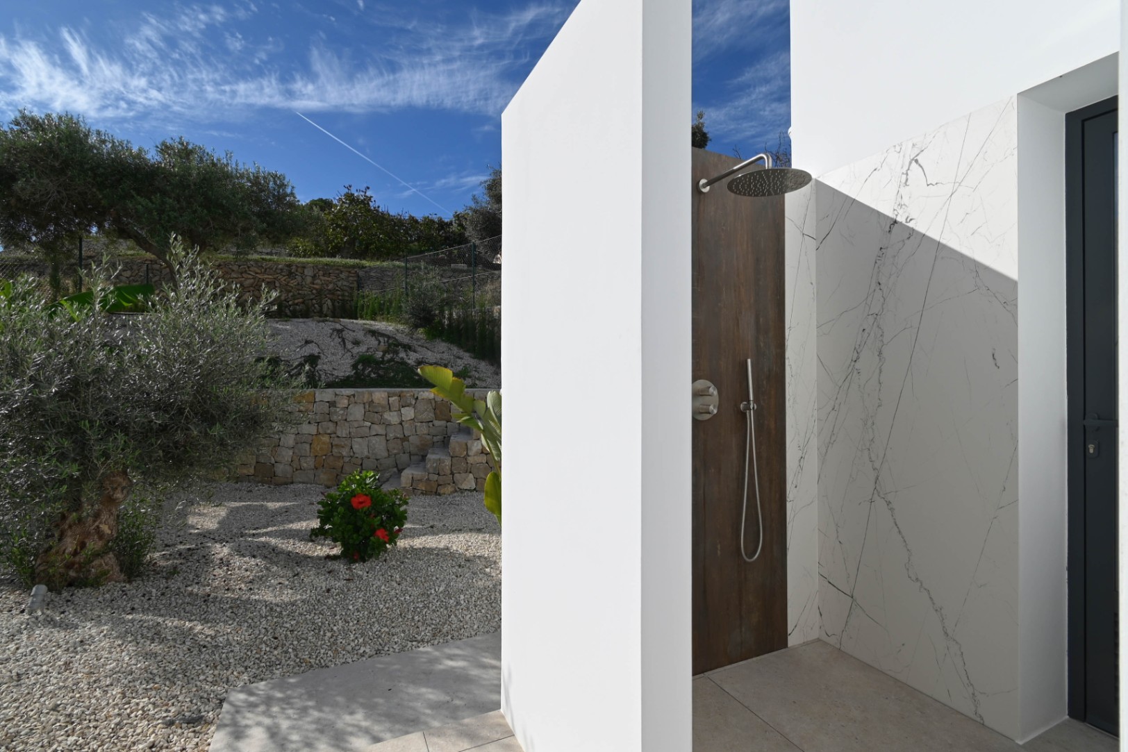 Outdoor shower and garden area at luxury villa near La Fustera Beach