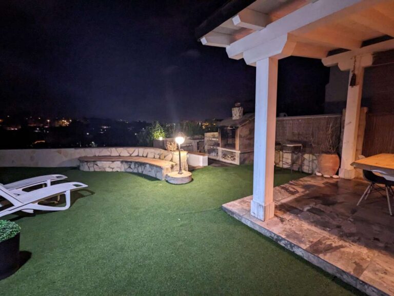 Outdoor terrace at night with garden lighting at a refurbished villa with sea views in Canuta, Calpe.