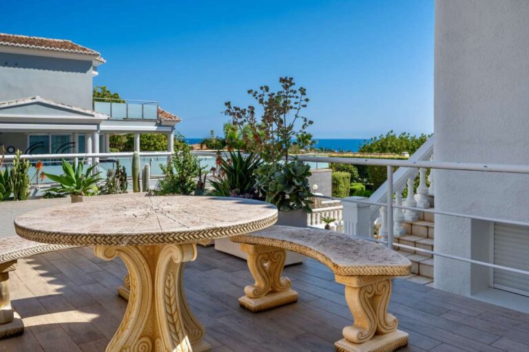 Outdoor terrace with seating and sea views at a villa in Calpe.