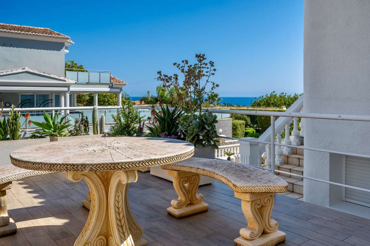 Outdoor terrace with seating and sea views at a villa in Calpe.