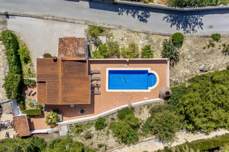 Overhead view of a charming Benissa Coast villa with private swimming pool, terrace, garden areas and red-tiled roof