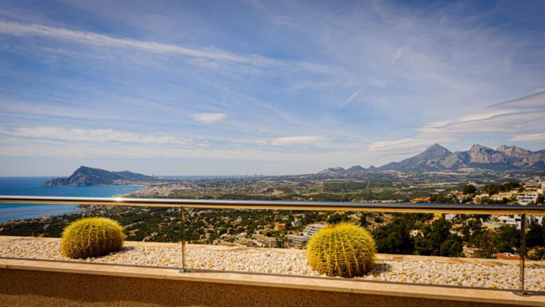 Panoramic views from a luxury apartment terrace in Sierra de Altea showing the Mediterranean Sea, mountains, coastline and terrace railing
