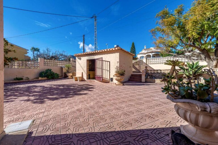 Parking area and garage beside a spacious villa with guest apartments in Calpe.