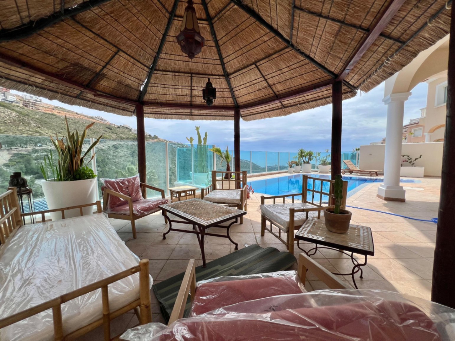 Pergola seating area with sea views at modern villa in Moraira