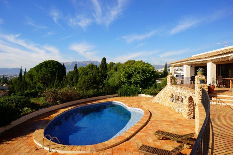 Pool and garden views at a Mediterranean villa in Calpe with private swimming pool, mature greenery and spacious outdoor terrace
