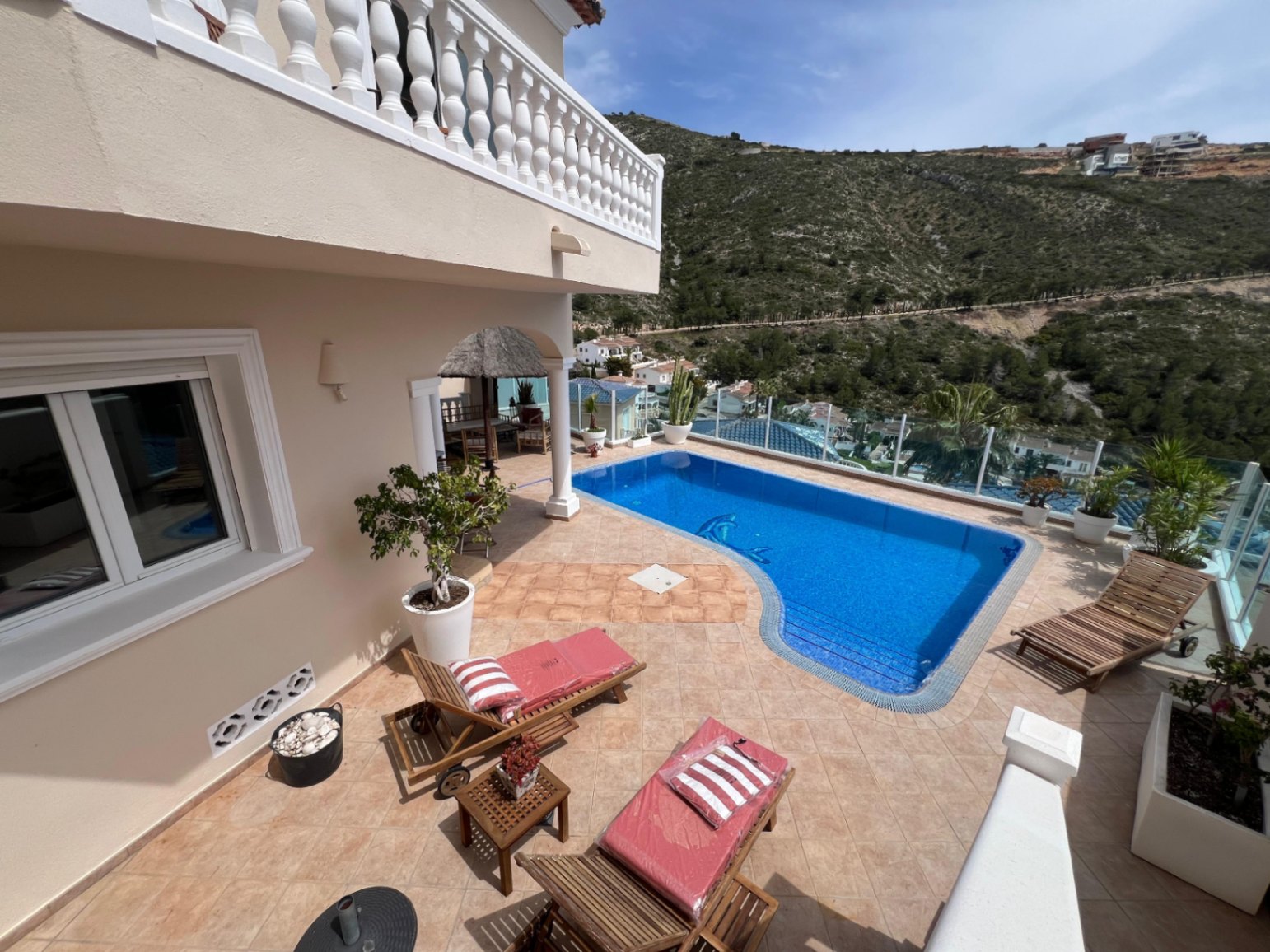 Pool area with terrace at modern three-level villa in Moraira