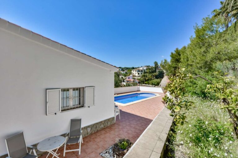 Pool terrace and side garden at a charming Benissa Coast villa with outdoor seating, Mediterranean planting and private swimming pool