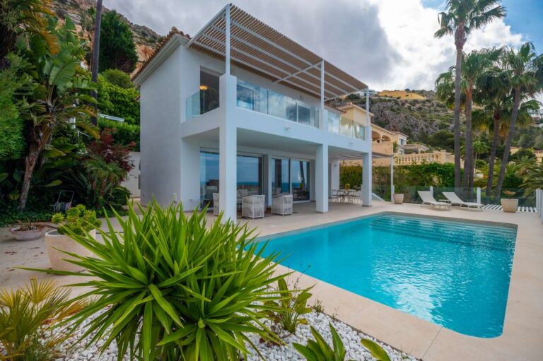 Pool terrace at a modern villa in Altea Hills with private swimming pool, glass balcony, outdoor seating and landscaped Mediterranean planting